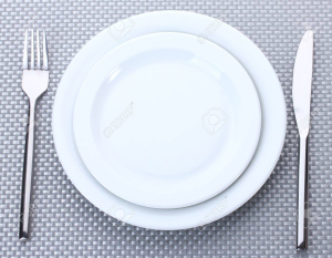 14077852-white-empty-plates-with-fork-and-knife-on-a-grey-tablecloth